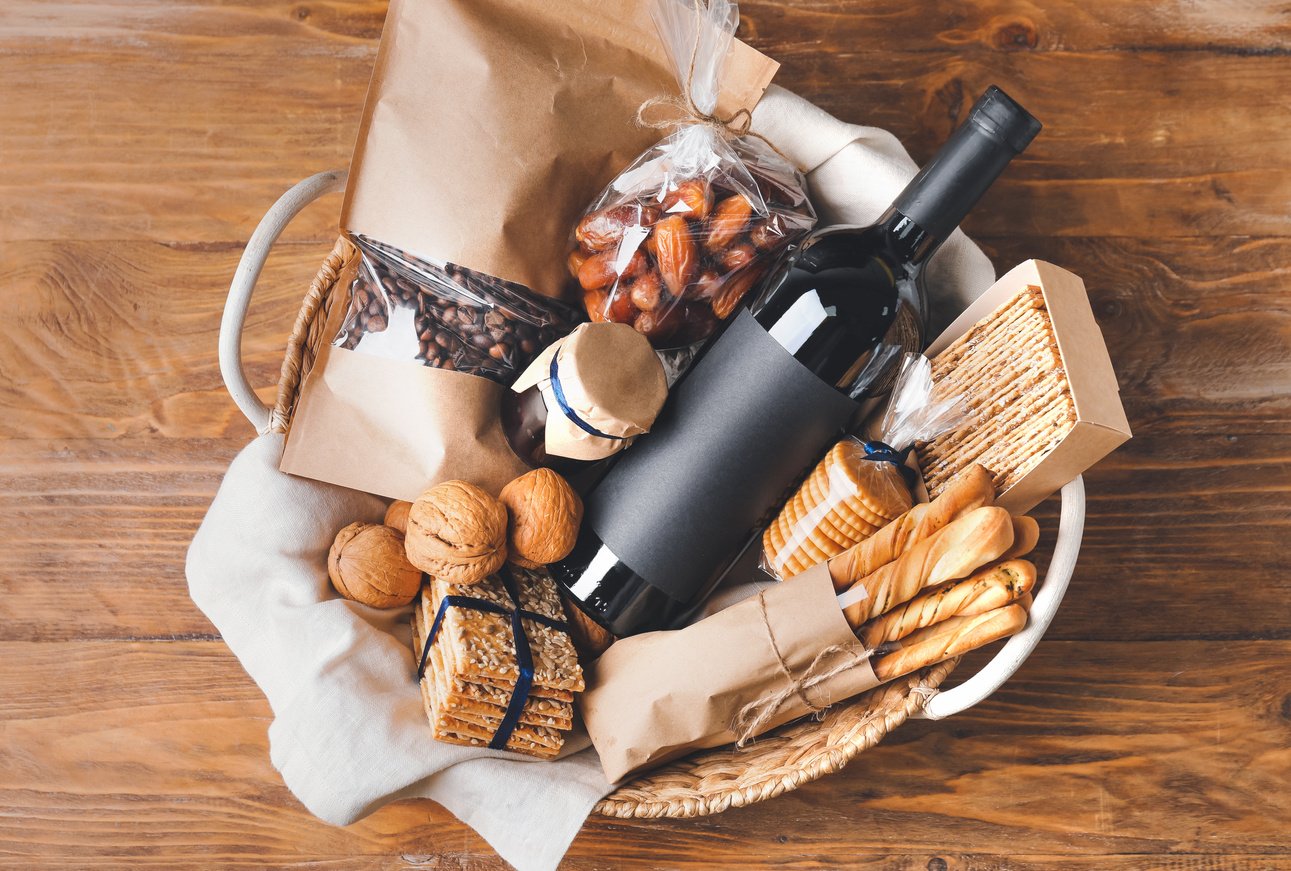 Gift Basket with Products on Wooden Background